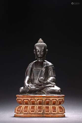 A HARDWOOD CARVED FIGURE OF SHAKYAMUNI WITH STAND