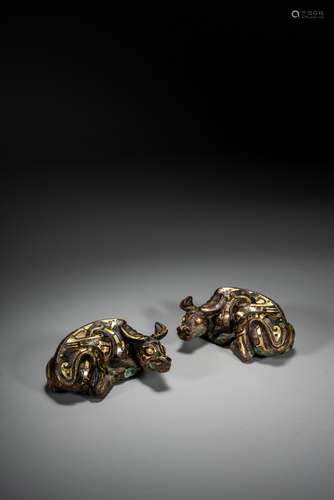 A PAIR OF BRONZE GOLD INLAID 'BUFFALO' PAPER WEIGHTS