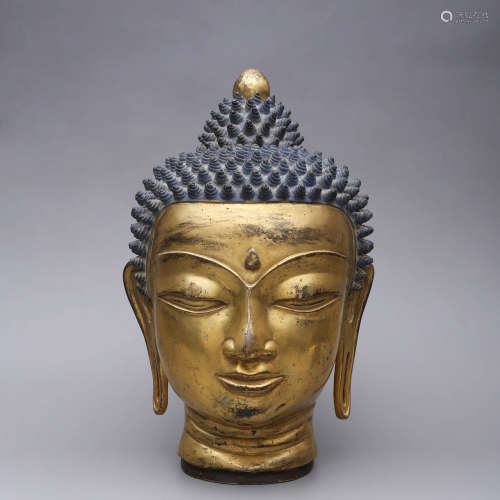 A GILT-BRONZE BUDDHA HEAD STATUE