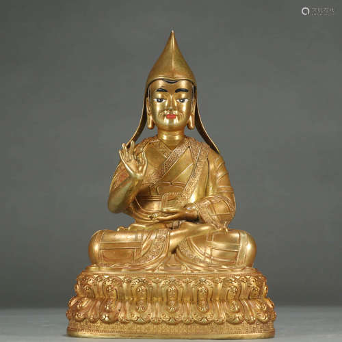 A GILT-BRONZE STATUE OF GURU BUDDHA