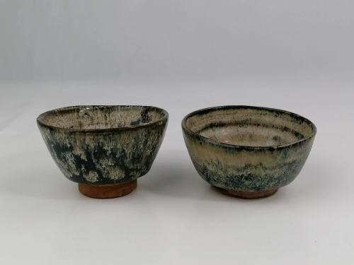 A pair of Japanese pottery tea bowls