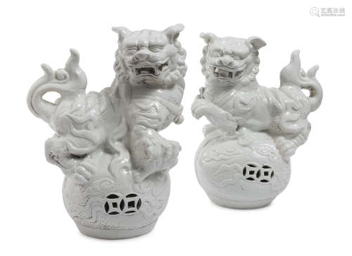 A PAIR OF CHINESE WHITE PORCELAIN SCULPTURES DEPICTING BUDDHIST LIONS 20TH CENTURY