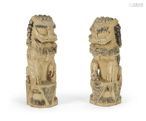 A PAIR OF CHINESE BONE SCULPTURES DEPICTING TWO GUARDIAN LIONS EARLY 20TH CENTURY.