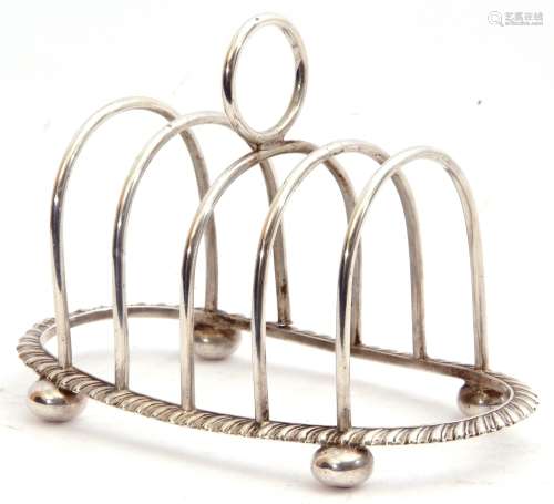 Edward VIII silver toast rack of oval form, four hoop divisions with central circular carrying