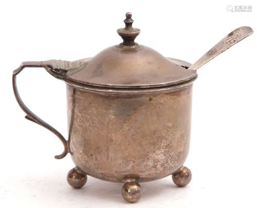 Victorian silver mustard of circular form, hinged lid with urn finial and angular handle, raised