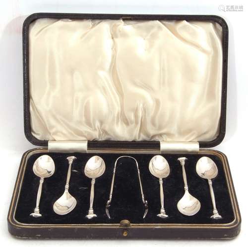 Cased George V silver tea spoon and tong set, the six fancy backed tea spoons with seal top finials,