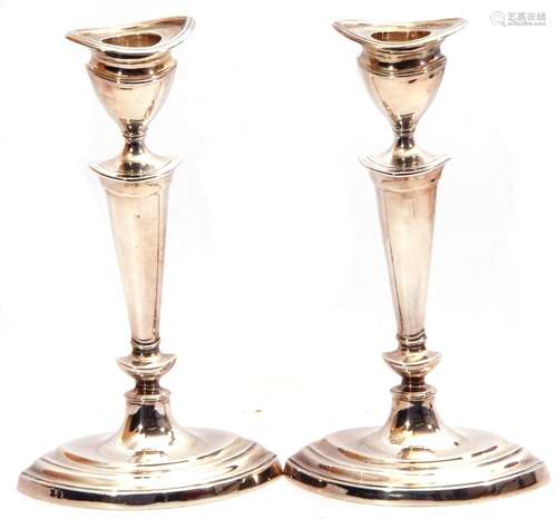 Pair of silver candlesticks of oval form, detachable reeded sconces, tapering knopped stems on a