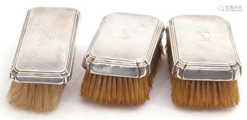 Group of three silver backed brushes, rectangular form, each engraved with a personalised