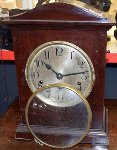 Mahogany cased mantel clock with German movement, circular Arabic chapter ring and bracket feet,