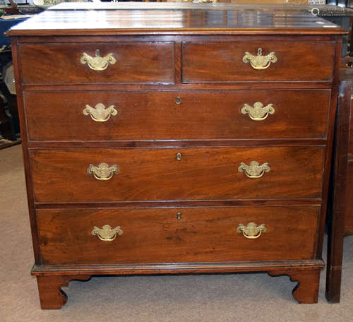 George III period mahogany chest of two and three drawers with engraved brass fittings, shaped