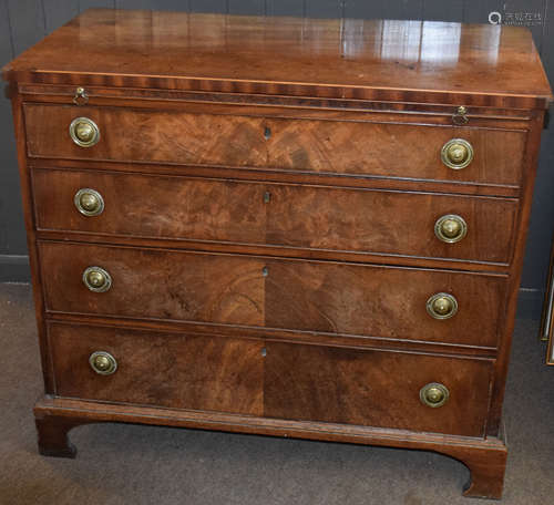 Late Georgian mahogany chest of four graduated drawers with circular embossed brass ring handles