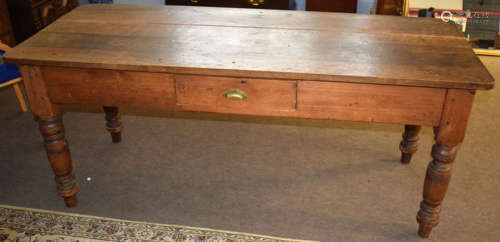 Stained pine kitchen table, of rectangular form with single frieze drawer raised on turned supports,