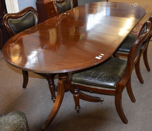 Regency style mahogany twin pedestal dining table, oval shaped, and featuring an inset leaf, top