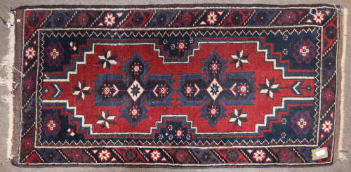 Small 20th century Caucasian wool rug, geometric decoration in red, blue and cream, 130cm x 69cm
