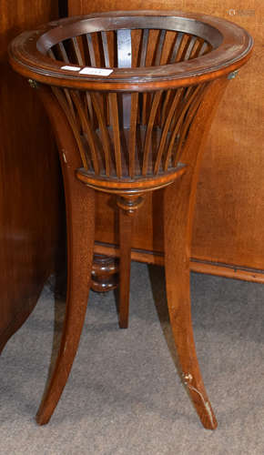 Edwardian period mahogany jardiniere of comb sided circular form, raised on three inlaid curved