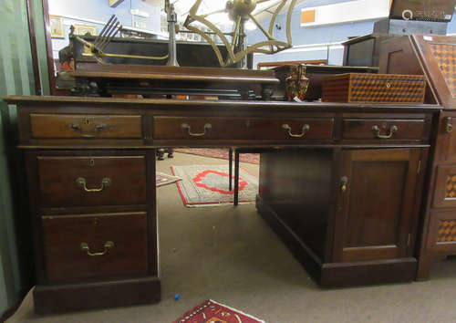 Late 19th/early 20th century mahogany partner's desk with gilt tooled red inset, the two pedestals