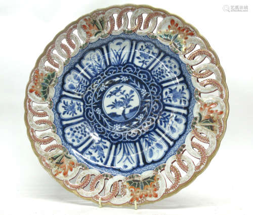 Japanese porcelain large plate with a pierced border, the centre with a floral design in Chinese