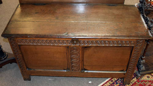 18th century oak coffer with staple fixed two-part top, wavy carved frieze and uprights, two plain