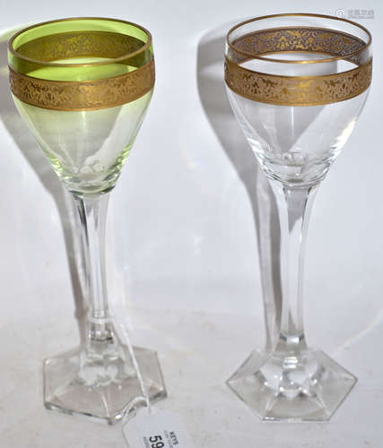 Pair of wine glasses, probably Moser, with green tint and a gilt engraved band above a faceted