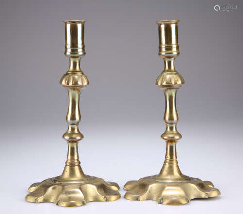 A PAIR OF 18TH CENTURY BRASS PETAL BASE CANDLESTIC