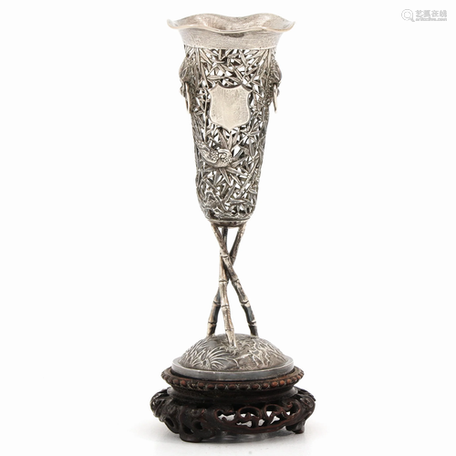 A Silver Vase on Wood Base