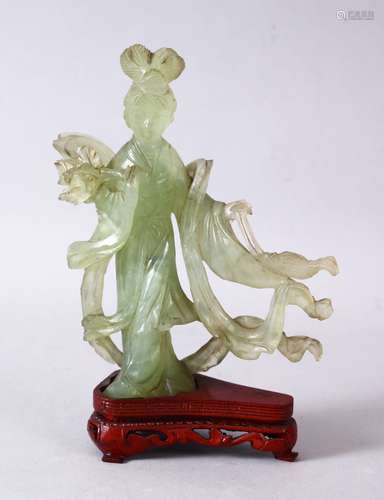 A 19TH / 20TH CENTURY CHINESE CARVED JADE FIGURE OF GUANYIN, upon a carved wooden base, 16cm x 11cm