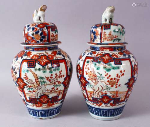 A PAIR OF MEIJI PERIOD IMARI VASES AND COVERS, with kylin finials, overall 30cm high.
