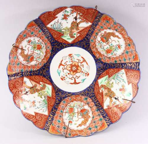 A JAPANESE IMARI CHARGER, with shaped edge, painted with six panels, alternatively painted with