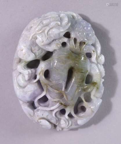 A CHINESE CARVED HARDSTONE ROUNDEL, carved with kylin and naturalistic forms, 8cm x 6cm.