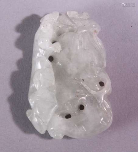 A CHINESE CARVED AND PIERCED JADE AMULET, carved with animal and fruit, 5cm x 3.5cm.