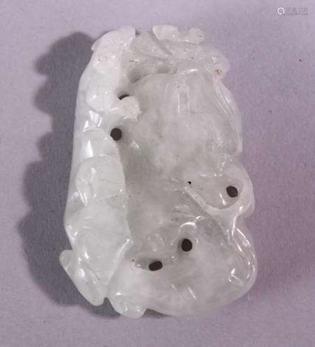 A CHINESE CARVED AND PIERCED JADE AMULET, carved with animal and fruit, 5cm x 3.5cm.