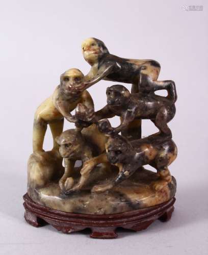 A 20TH CENTURY CHINESE CARVED SOAPSTONE MONKEY GROUP, carved with five monkeys climbing upon one and