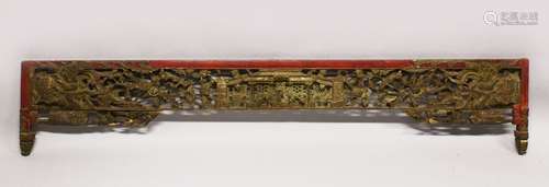 A CHINESE CARVED GILDED AND LACQUERED HEADBOARD PANEL, (AF), 190cm long, 35cm at widest point.