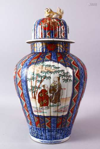 A LARGE IMARI VASE AND COVER, the ribbed body painted with panels of flowers and figures, the