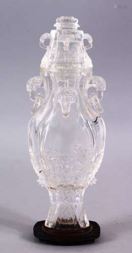 AN 18TH CENTURY CHINESE CARVED ROCK CRYSTAL VASE AND COVER, with rams head and ring handles, with