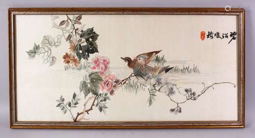 A CHINESE 19TH / 20TH CENTURY EMBROIDERED TEXTILE OF PEKING DUCK WATERSIDE, amongst native sprays of