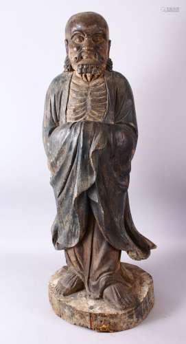 A 18TH/19TH CENTURY CHINESE CARVED WOOD FIGURE OF ROHAN, on a shaped base, 90cm high.