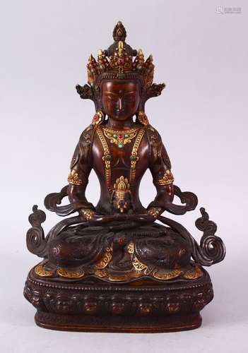 A CHINESE GILT BRONZE INLAID FIGURE OF A DEITY / BUDDHA, in a seated position with an object in