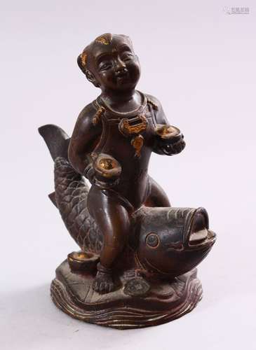 A SMALL CHINESE BRONZE FIGURE OF A BOY SEATED UPON A CARP, 15cm high.