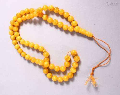 A CHINESE QING DYNASTY CARVED AMBER PRAYER BEADS / ROSARY NECKLACE, comprising 66 beads, 3 spacers