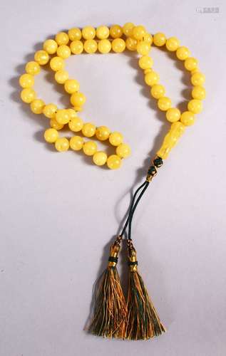 A CHINESE QING DYNASTY CARVED AMBER PRAYER BEADS / ROSARY NECKLACE, comprising 53 beads, 5 spacers