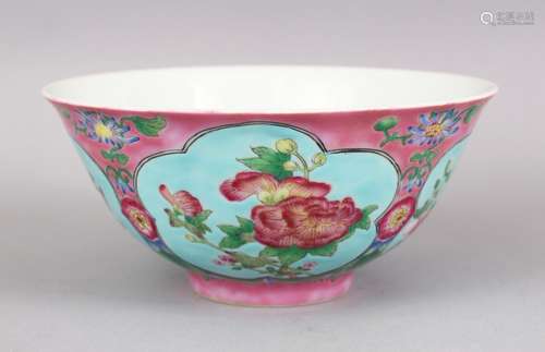 A CHINESE PINK GROUND FAMILLE ROSE PORCELAIN BOWL, with panels of native flora on a blue ground, the