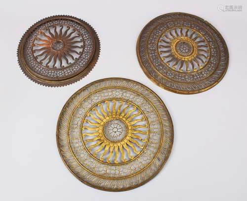 THREE 18TH / 19TH CENTURY INDIAN GILT METAL DOOR MOUNTS, each formed with openwork, 20cm diameter.