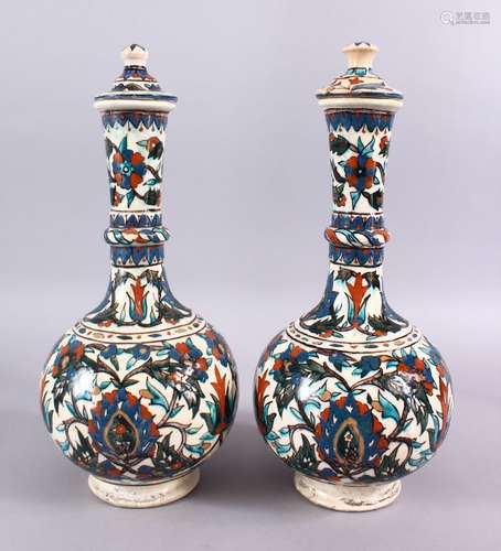 A LARGE PAIR OF 19TH CENTURY OTTOMAN TURKISH KUTAHIYA LIDDED PORCELAIN BOTTLE VASES,each with floral