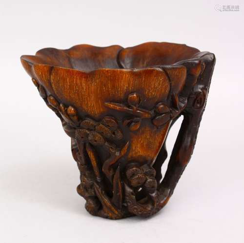 A GOOD LATE 19TH CENTURY CARVED RHINO HORN LIBATION CUP, the body with prunus and blossom, 12cm