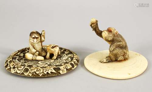 TWO JAPANESE MEIJI PERIOD CARVED IVORY TUSK VASE LIDS, one carved depicting a monkey holding a