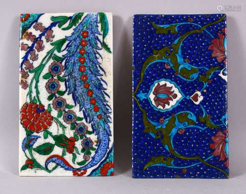 TWO IZNIK DECORATED PORCELAIN FRAGMENT TILES, one with ablue ground, the other with white, both with