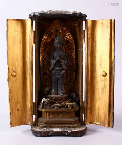 A 19TH CENTURY JAPANESE CARVED WOODEN ENCLOSED FIGURE OF KWANNON / DIETY, housed within a wooden