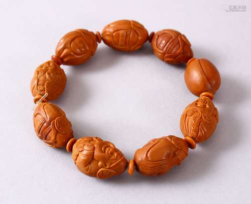 A CHINESE CARVED NUT BRACELET.