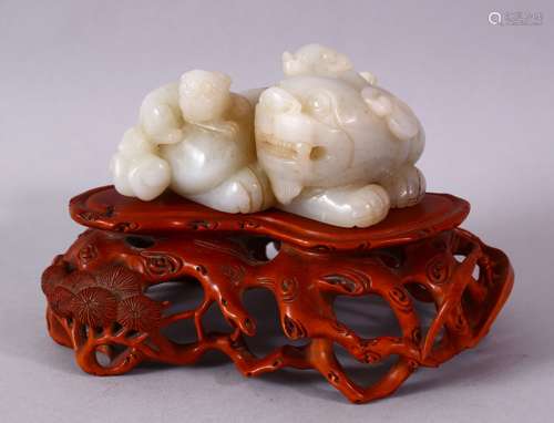 A GOOD CHINESE CARVED WHITE JADE FIGURE OF THREE LION & BOXWOOD STAND, one larger dog with two young